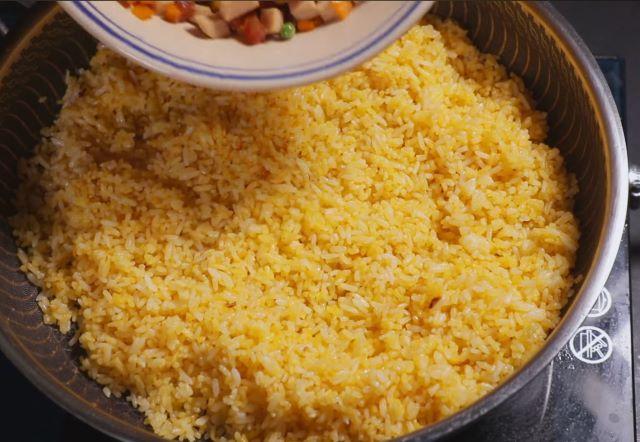 Chiên cơm sau đó cho topping đã xào vào chiên cùng rồi nêm nếm gia vị - Ảnh sưu tầm