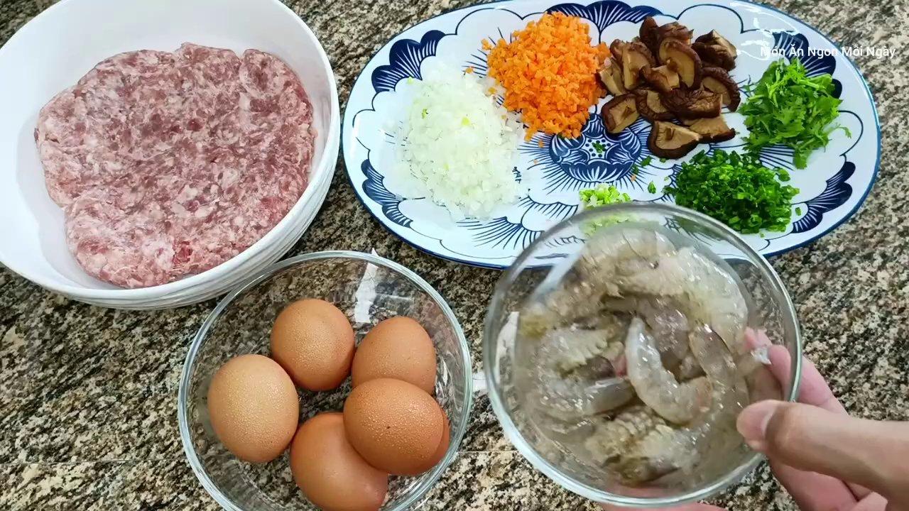 Nguyên liệu chính gồm thịt chân giò, tôm tươi và các loại rau củ như hành tây, cà rốt đã được sơ chế sẵn sàng.